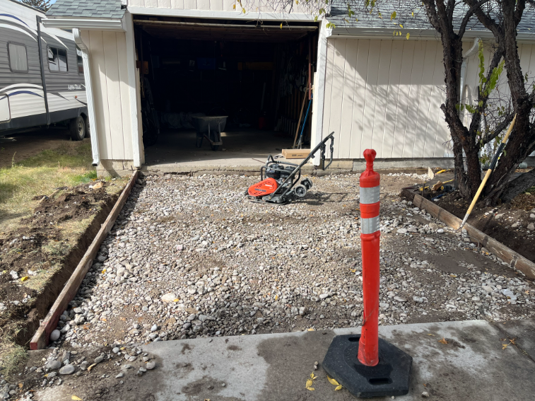 Gravel base prepared for a new garage driveway