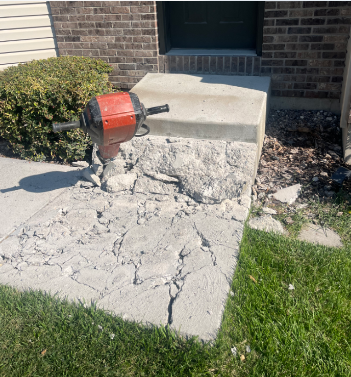 Crumbling concrete entry steps before the project