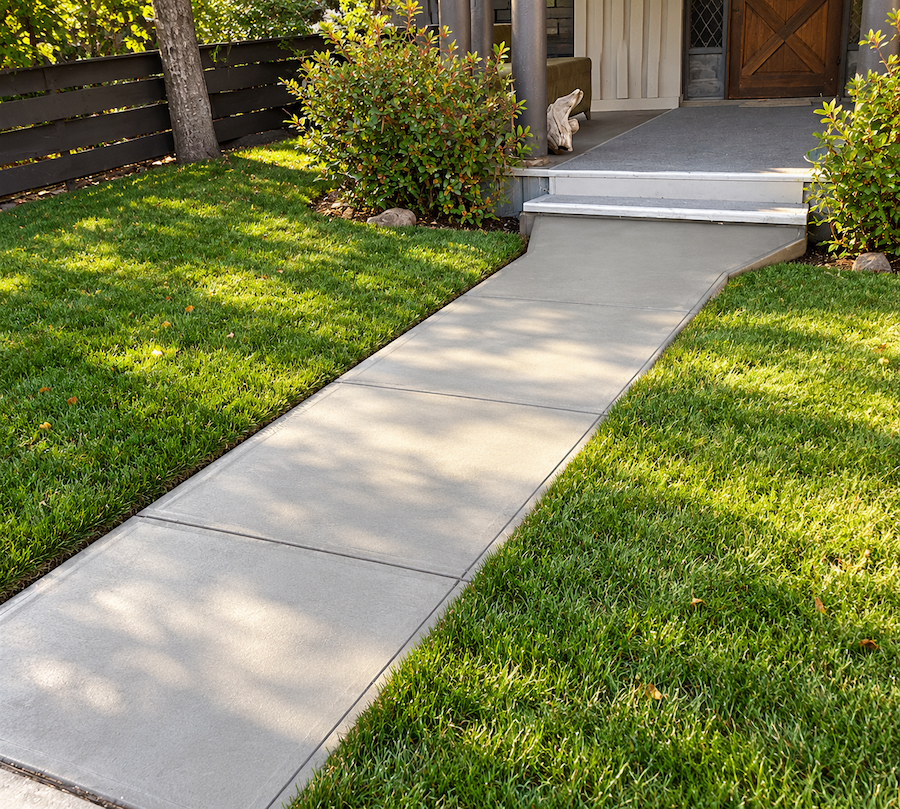 New concrete walkway leading to a front entry